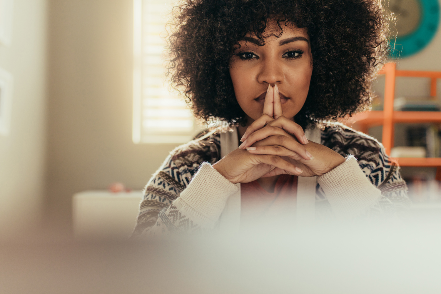 Woman sitting at her desk and thinking.