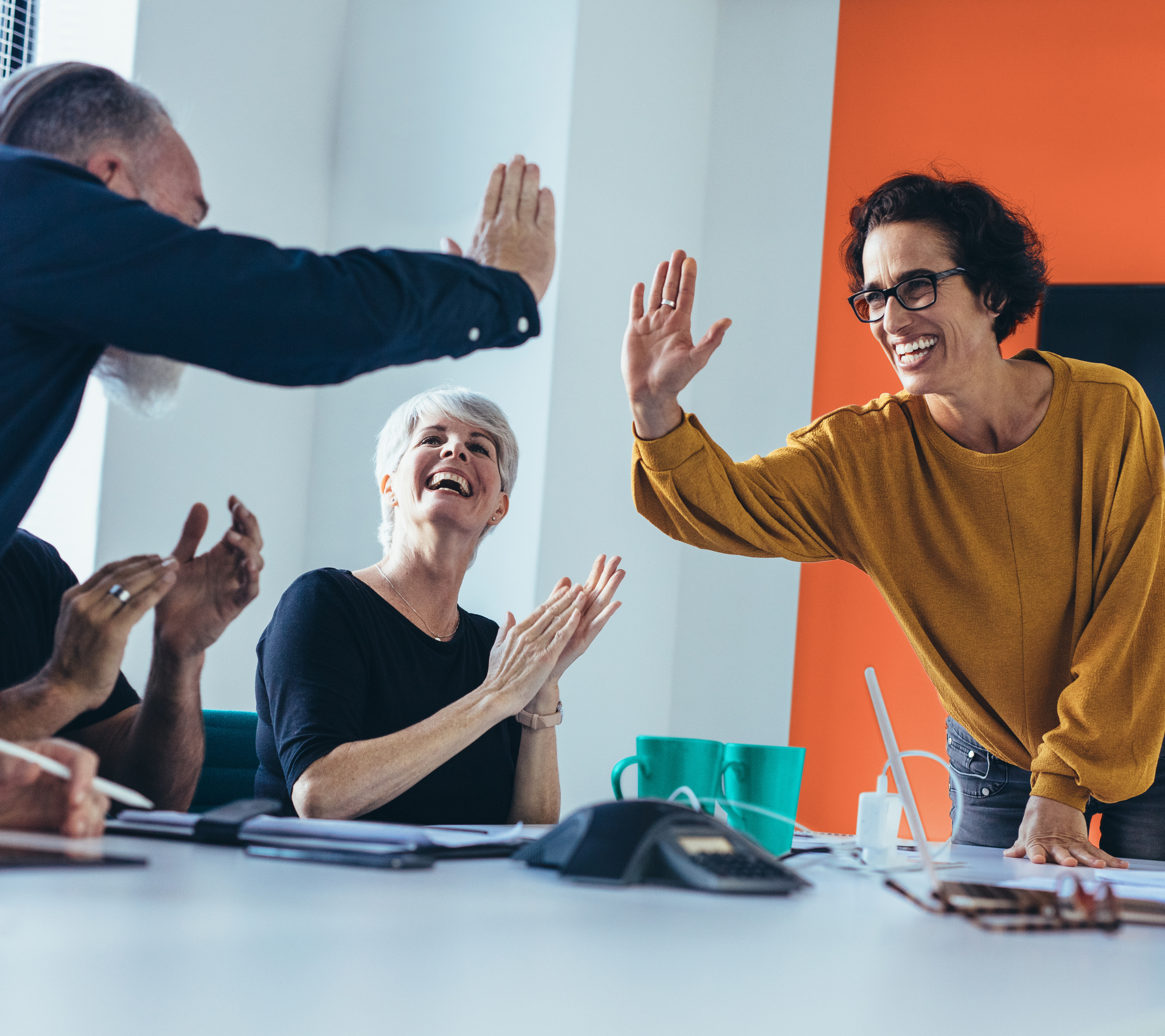 A female leader high fiving a member of her team